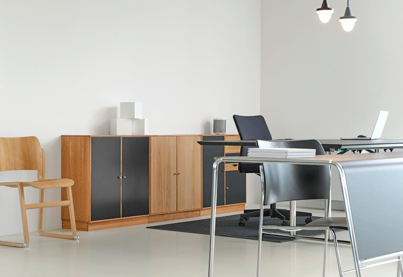 about-us A clean and organized modern office space with stylish furniture and decor.